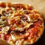 Prosciutto, anchovy and onion pizza. | By Sebastian Mary